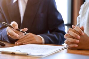 A professional male real estate agent or business consultant is meeting, talking, and giving business investment strategy advice to his client.